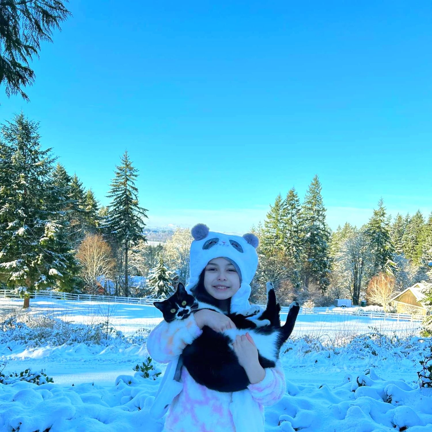 "Quinn Cornelio and her mustache kitty 'Stashia.' Stashia was not a fan of the snow, and after taking these photos she hopped back inside to safety." Photo taken by Kaleb Gaskill in Chehalis.